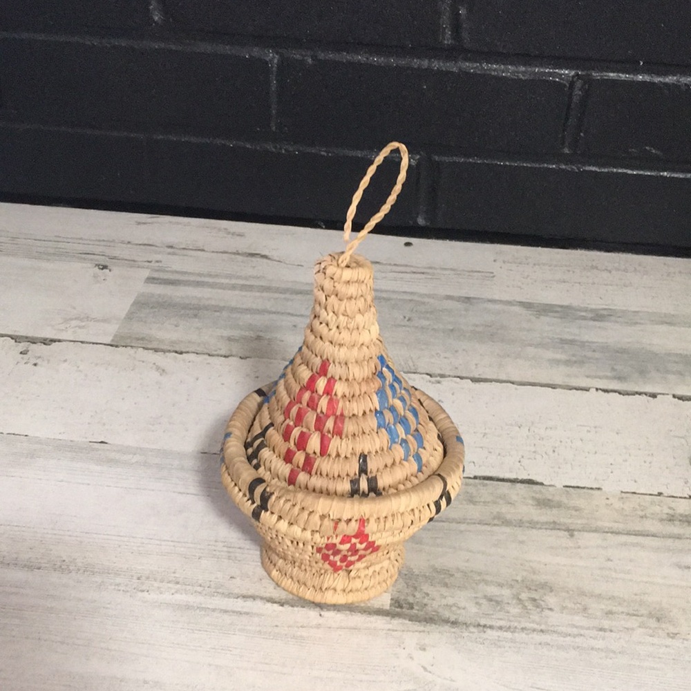 Small tan/red/blue/brown woven conical shaped basket with removable lid
